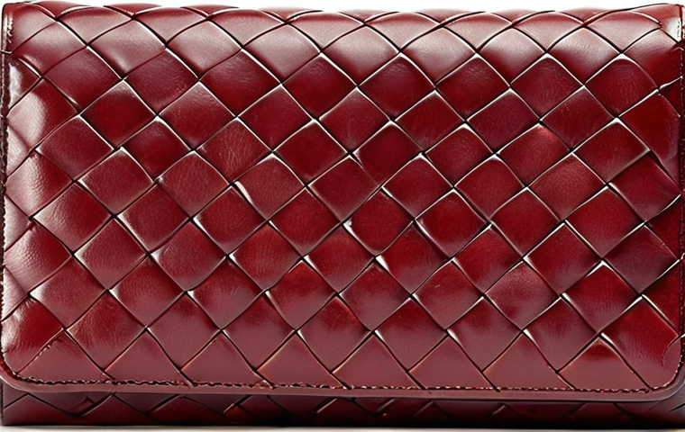 **Bottega Veneta: Classic Intrecciato Leather Wallet** - Focus on the intricate woven leather texture, showcasing understated elegance and timeless design. Emphasize high-quality craftsmanship.